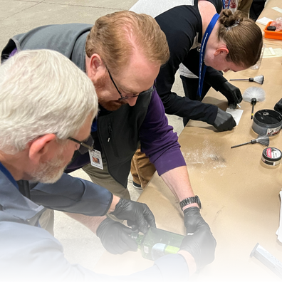 People dusting for fingerprints. 